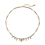 Multicolored beaded necklace with floral charms on a white background