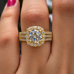 Gold ring with a large diamond on a person's finger