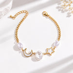 A delicate gold chain bracelet featuring a crescent moon, a star, and white pearl-like beads, displayed on a clean white background.