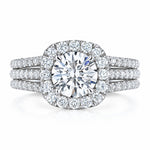 Diamond ring with a halo and additional stones on a white background