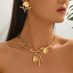 Gold necklace and earrings on a model with a blurred background
